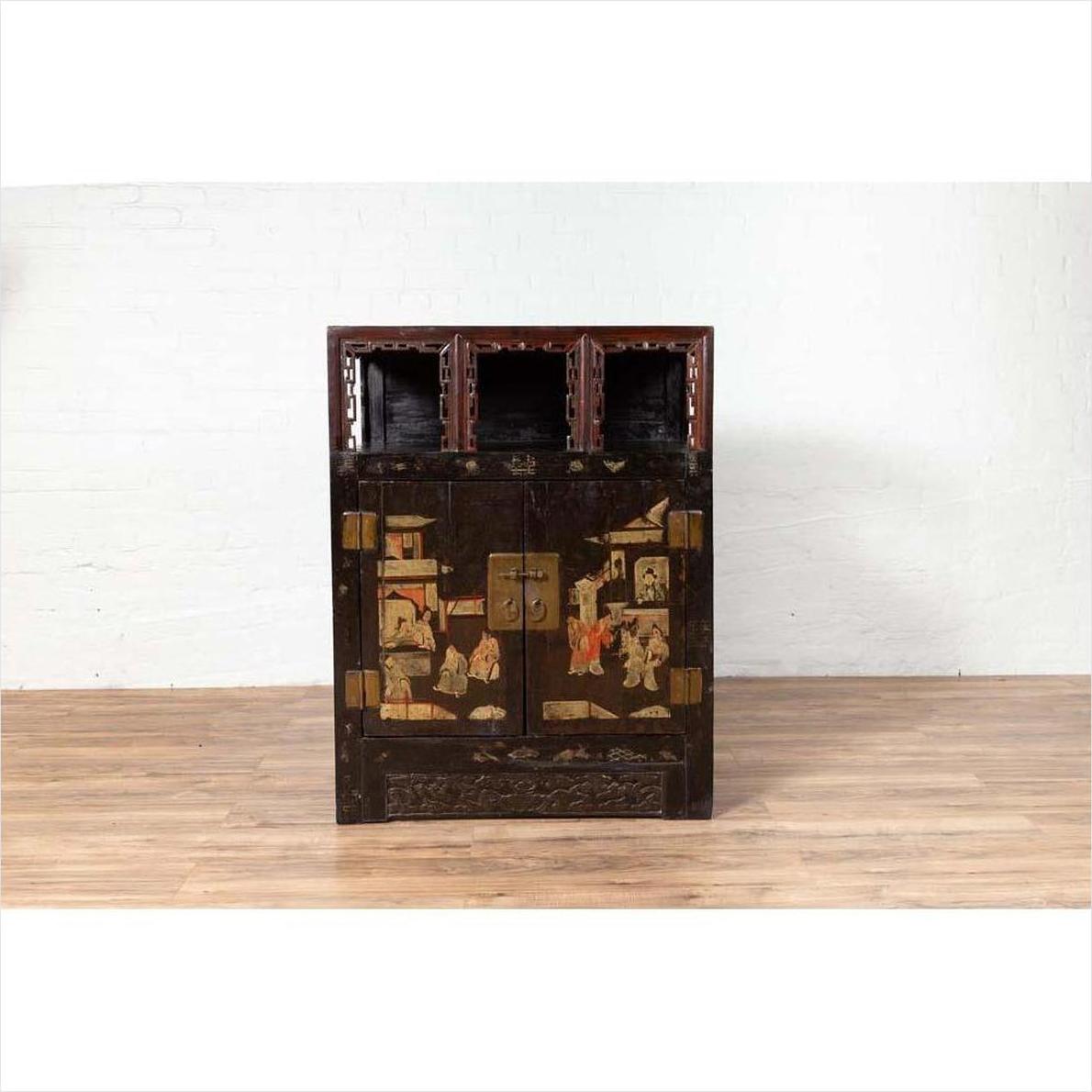Black lacquer wood Chinese display cabinet with hand painted chinoiserie, three open shelves, against white wall.