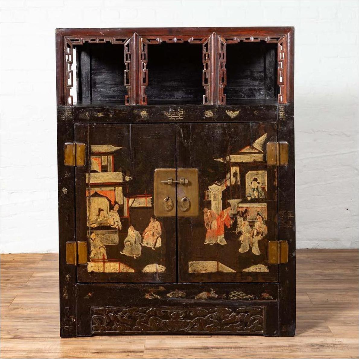 Black lacquered wood Chinese display cabinet with hand painted chinoiserie, open shelf, and brass handles.