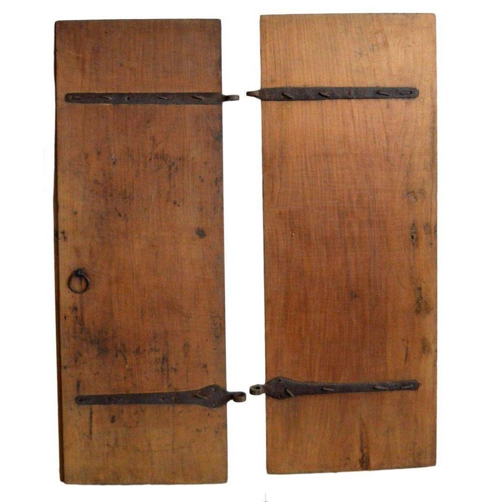 Natural wood antique Chinese doors with black metal hinges, round left-side handle, and aged patina, front view.