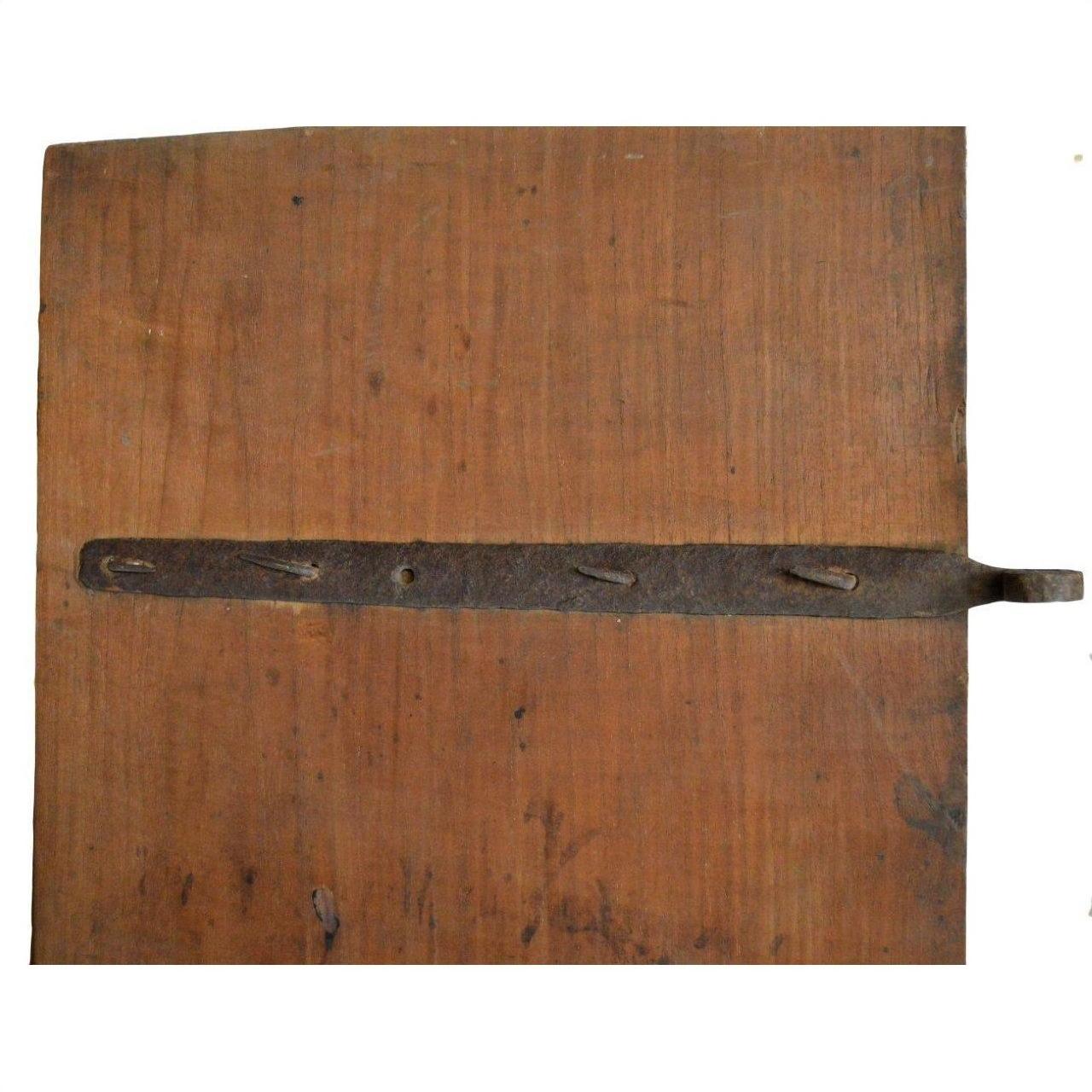 Brown wooden antique Chinese doors with horizontal metal hinge, plain white background.