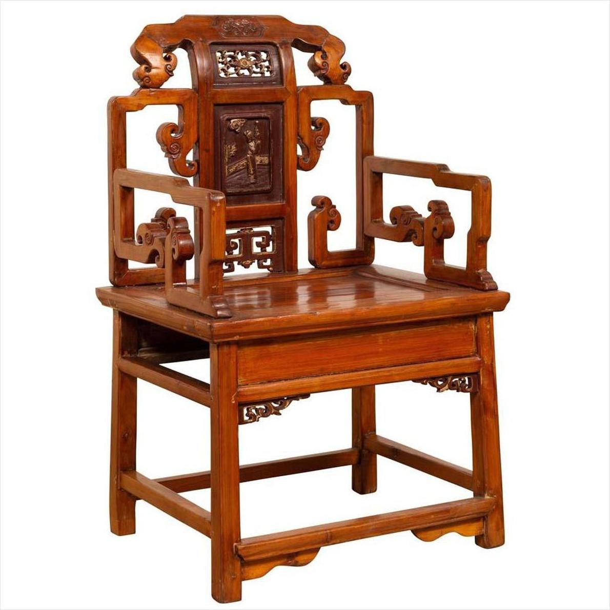 Natural wood antique Chinese chair with carved backrest and arms, hand-carved details visible, indoors.