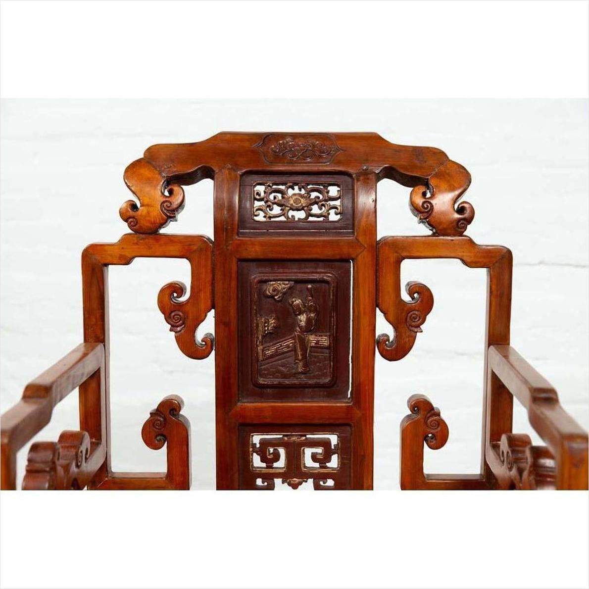 Natural wood antique Chinese hand-carved chair with intricate scrollwork and carvings, on white background.