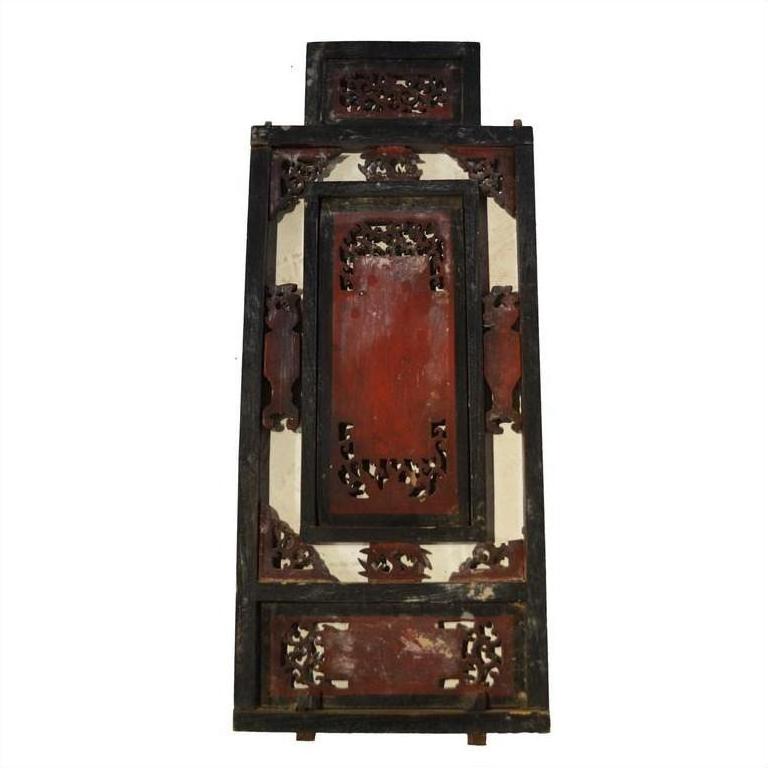Red lacquer and gilt wood Chinese panel, close-up of intricate multi-figure carving and scroll details.