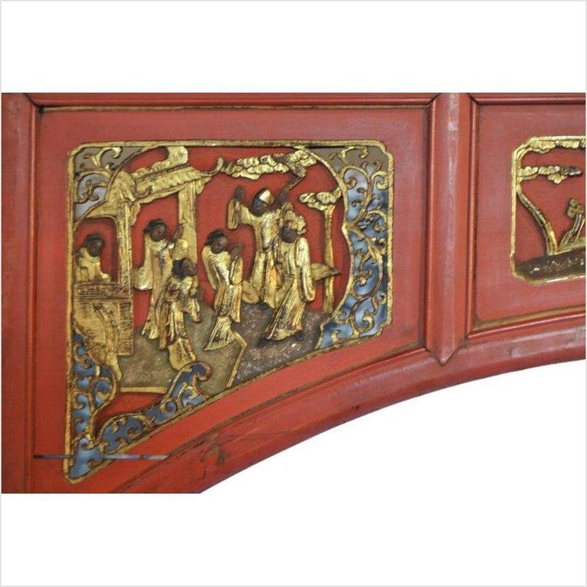 Red and gold wooden sign with hand-carved relief figures, blue and gold accents, antique style.