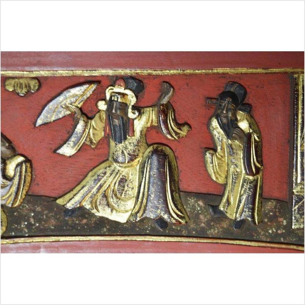 Brown wood sign with carved figures in traditional robes, black hats, and beards; one holding a fan.