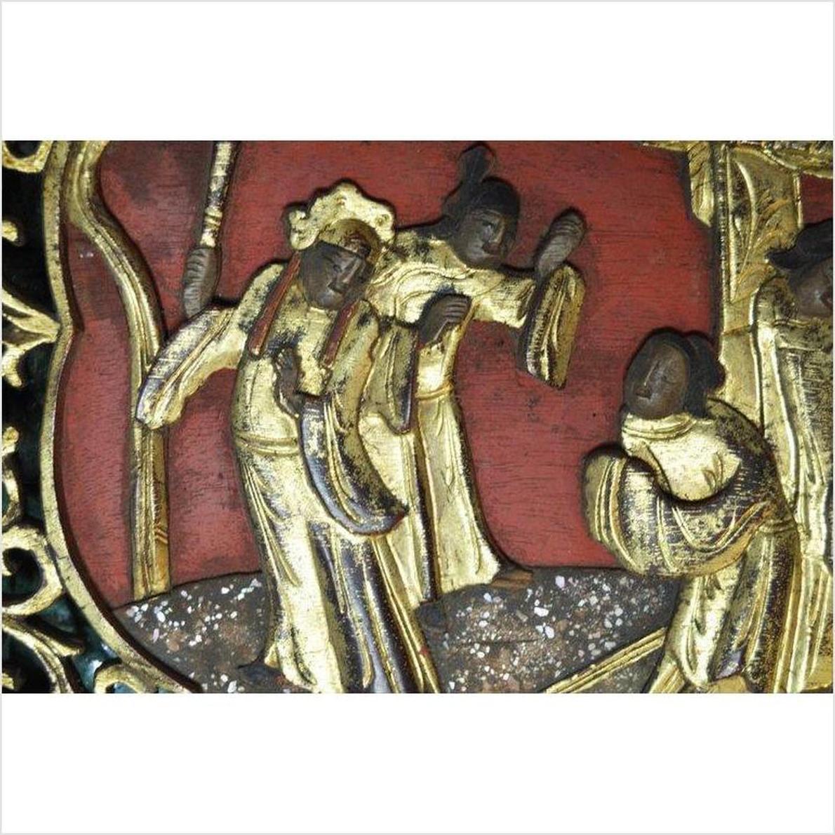 Red wood hand-carved sign with gold relief of three robed figures, red background, antique style.