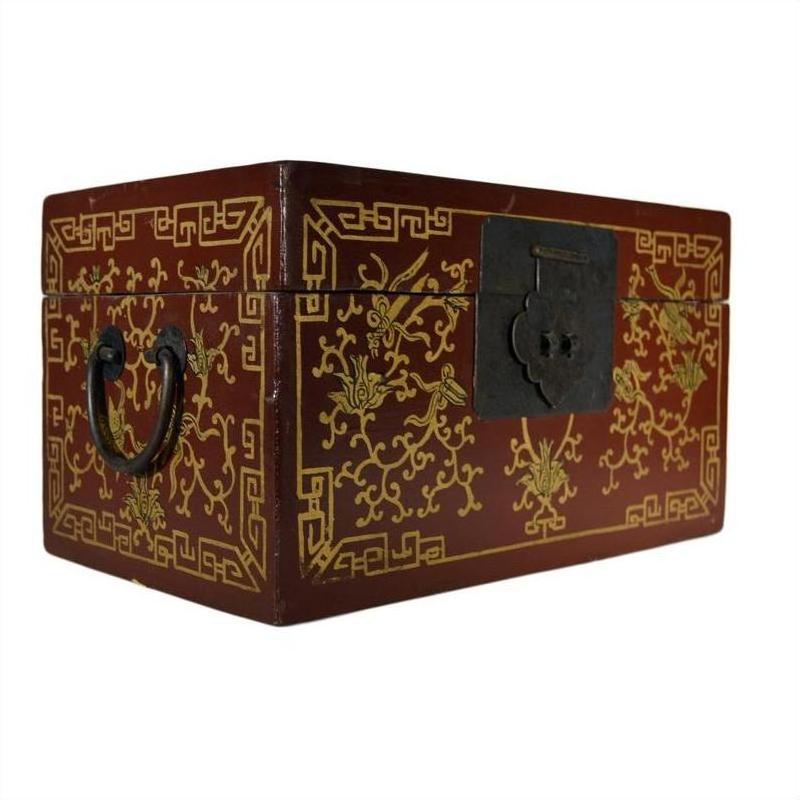 Black and gold lacquered Chinese box with central latch, stylized bird design, ornate hand-carved gilt patterns, close-up.