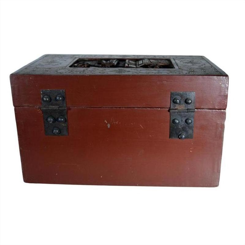 Black lacquered box with central latch and stylized bird design on lid, antique, shown in plain setting.