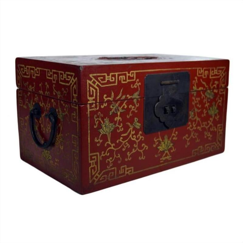Black and gold lacquered Chinese box with phoenix motif, gilt vine patterns, black metal handles, and front latch, close-up.