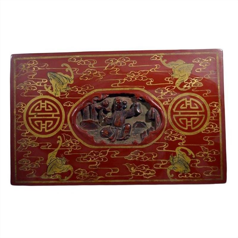 Red lacquer rectangular box with gilt phoenix and vine designs, antique Chinese style, close-up view.
