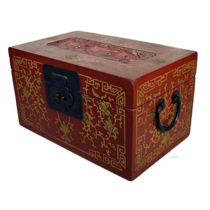 Close-up of red lacquer Chinese box with gold floral inlay, metal handles, and ornate clasp on decorated top panel.