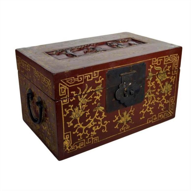Red lacquered Chinese antique box with gilt floral designs, dancing figures on scenic lid, metal latch, and side handles.