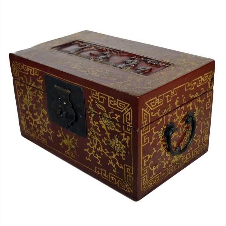 Black and gold lacquered Chinese box with gilt floral details, dancing figures on scenic lid, black handles, decorative lock.