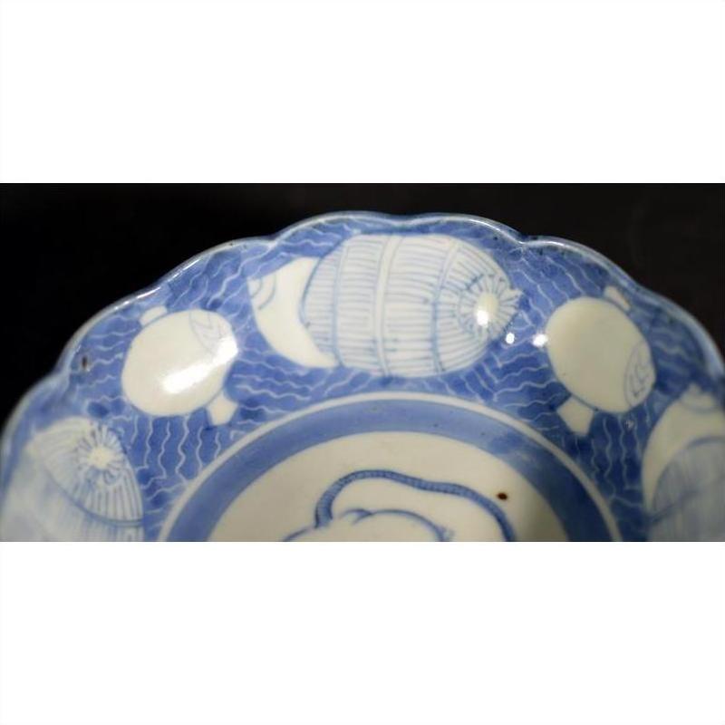 Blue and white ceramic scalloped dish with crouching mouse, barrel cartouche, and aquatic patterns.