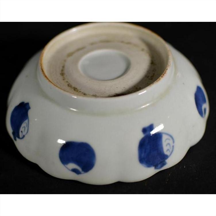 White ceramic scalloped dish with crouching mouse and barrel cartouche, shown upside down on plain background.