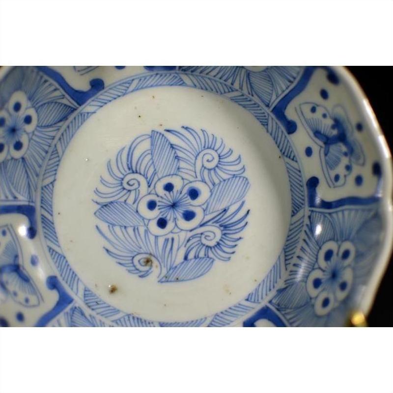 White porcelain bowl with butterfly cartouches, petal rim, and intricate decorative details, antique Chinese style.
