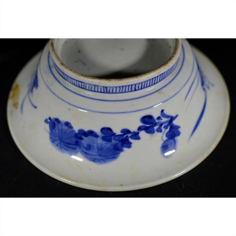 Blue and white ceramic deep plate with broad blue rim and minimal center, viewed from the bottom.