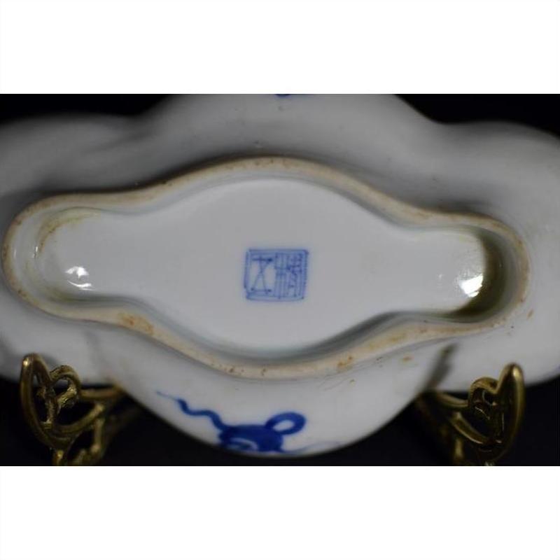 Close-up of blue and brass antique cloud-form dish base with figural scene, showing blue mark and ornate side stands.