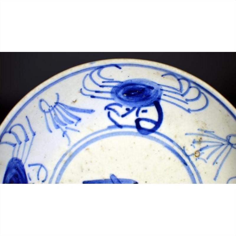 Close-up of antique hand-painted Chinese porcelain plate with Longevity and crab design, partial view.