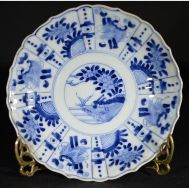 White porcelain plate with hand painted floral and bird designs, displayed on a brass stand.