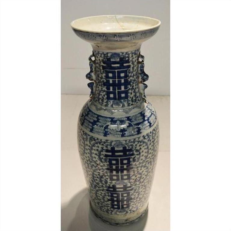 Blue and white porcelain antique vase with hand-painted intricate patterns and large double happiness symbols, close-up.