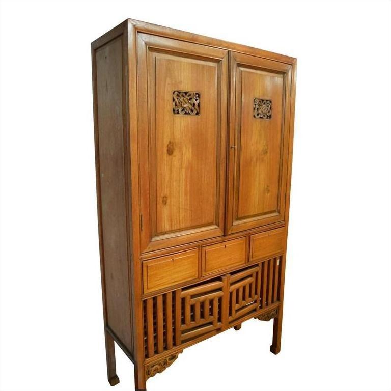 Dark wood Chinese kitchen cabinet with hand-carved frame, three drawers, and decorative legs, front view.