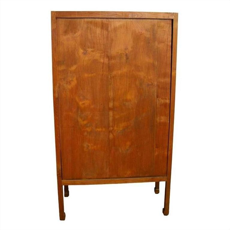 Brown wood antique Chinese kitchen cabinet with tall rectangular shape and hand carved framework on front.