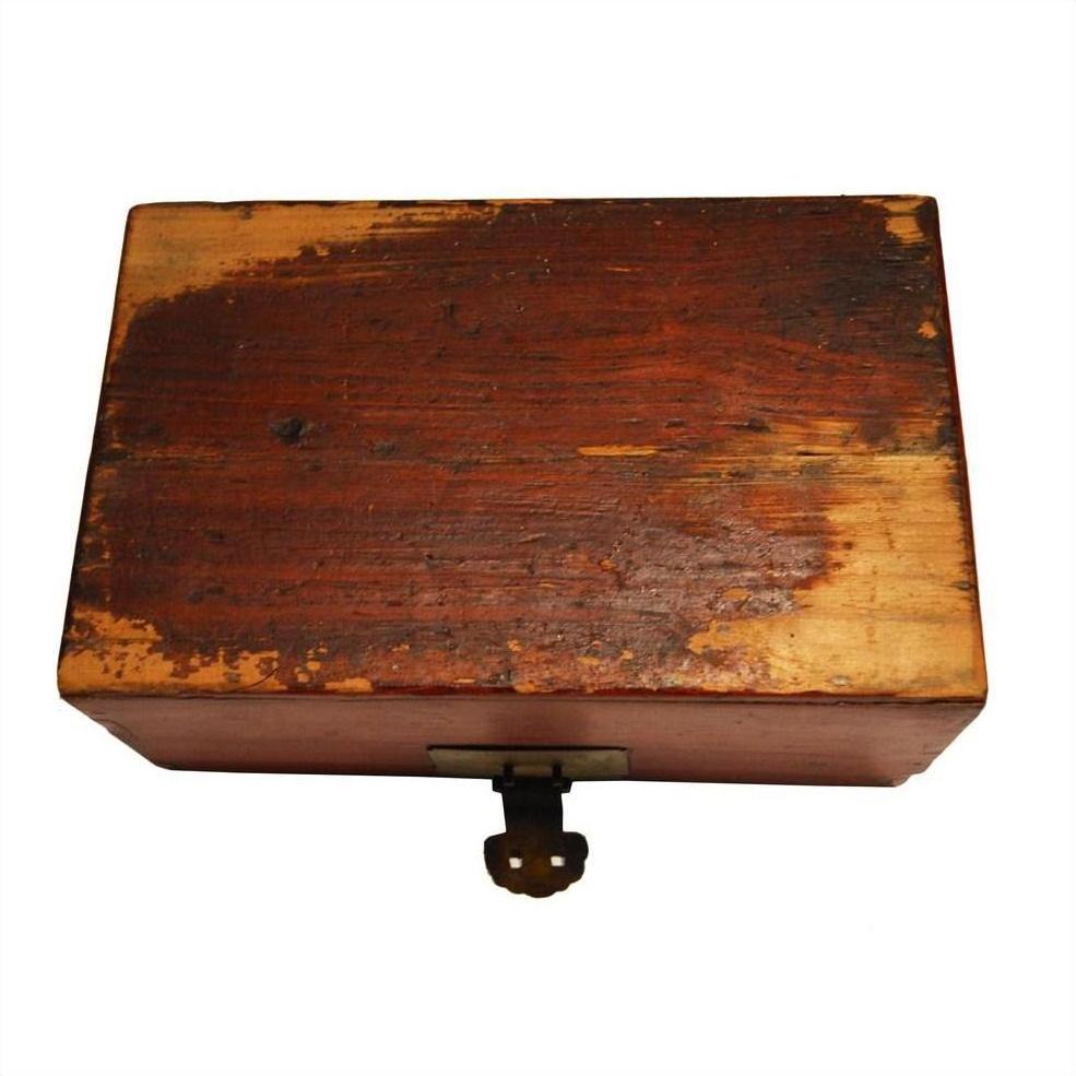 Black lacquered rectangular box with metal latch, visible age and surface scratches, antique style.