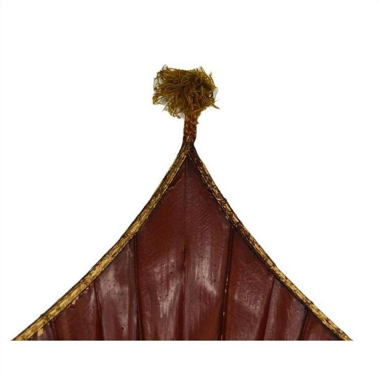 Close-up of pointed tops of antique Chinese large flags with tassels, white background.