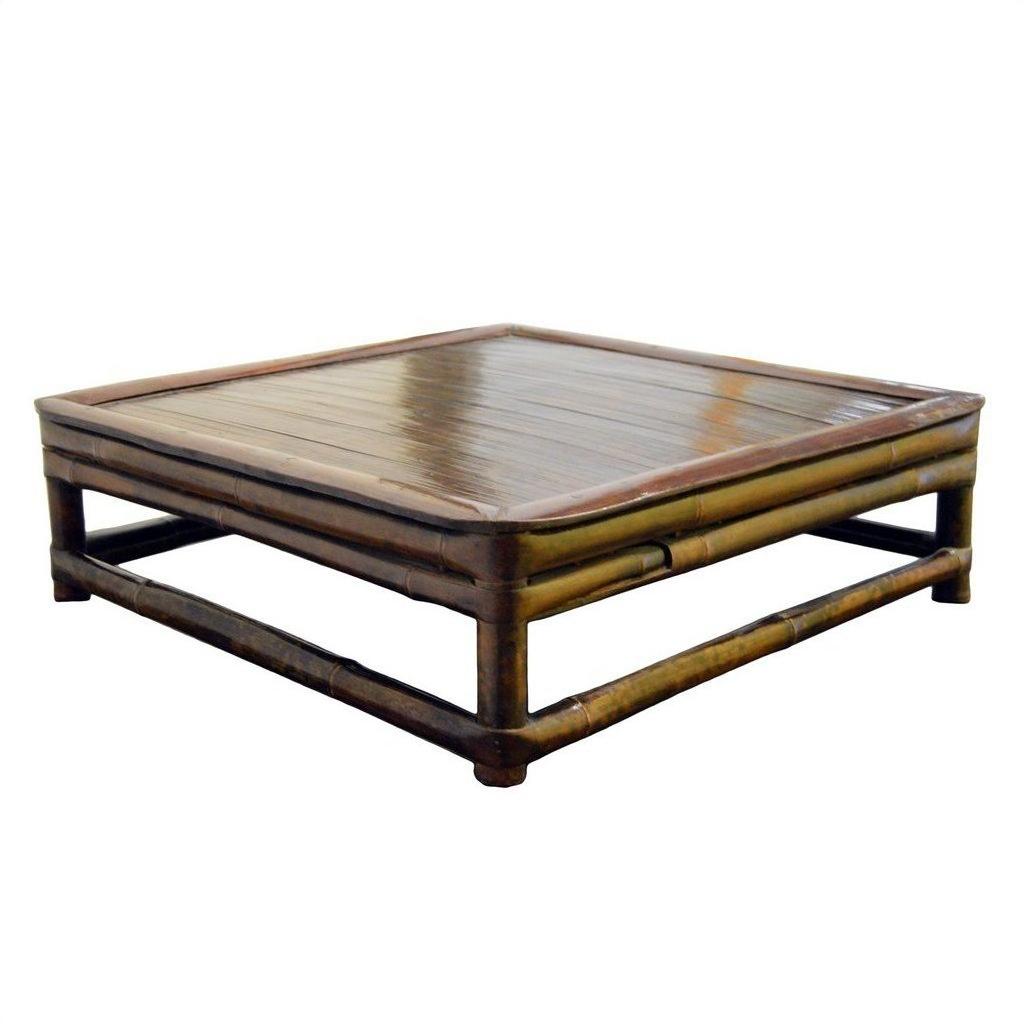 Brown wood antique Chinese low Kang square ceremonial prayer table against plain white background.
