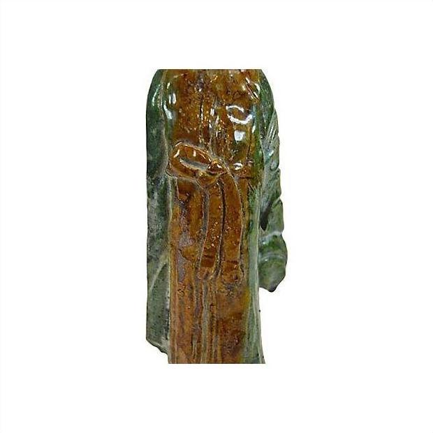Close-up of green and brown glazed terracotta court figure statue, Chinese robed design with tied belt detail.