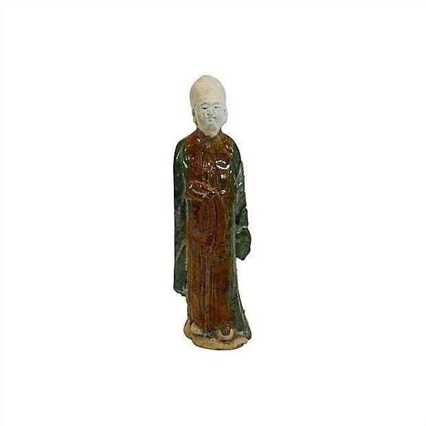 Terracotta antique court figure statue of a robed person with folded hands on plain white background.