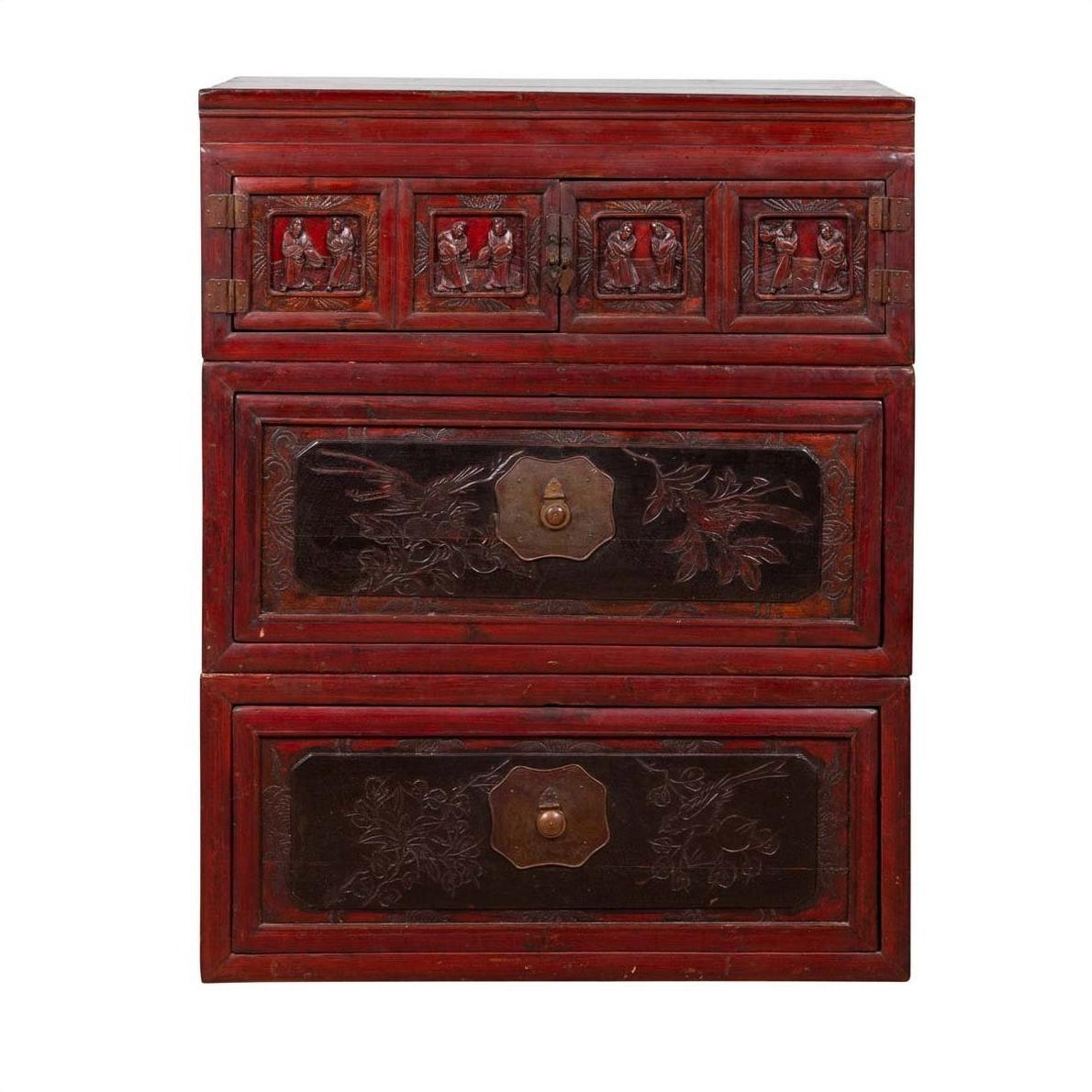 Red and black lacquered antique Chinese chest with three sections, carved figures, and floral panel details.