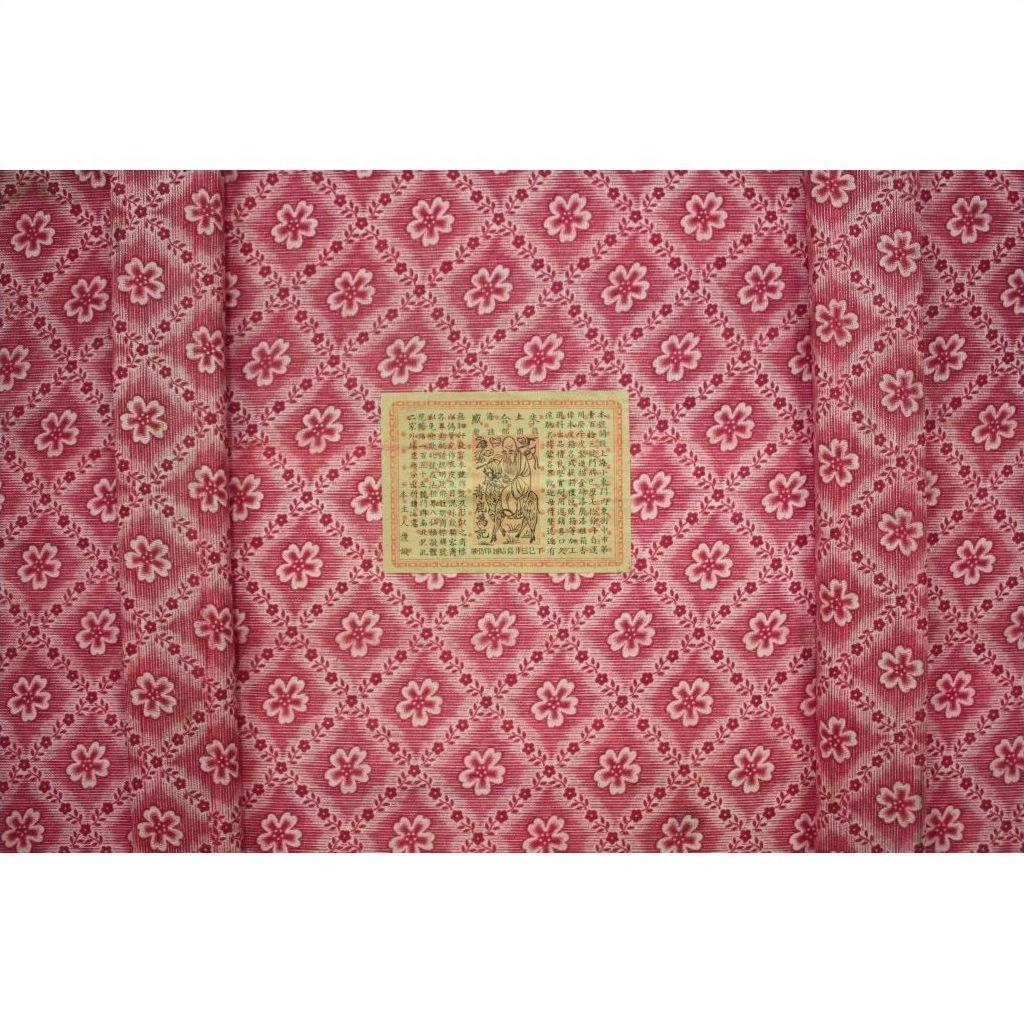 Close-up of red fabric with diamond and flower pattern, inspired by Antique Chinese Red Lacquer Blanket Chest.