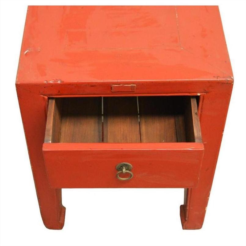 Red lacquer wood side table with horse-leg design, antique style, partially open drawer reveals wood interior.