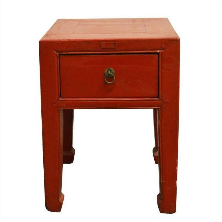 Red lacquered wood side table with one drawer, metal pull, and horsehoof-style legs, antique Chinese design.