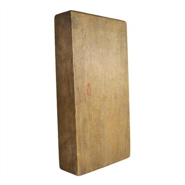 Brown wooden antique Chinese rice mold on plain white background, natural wood grain visible, close-up.