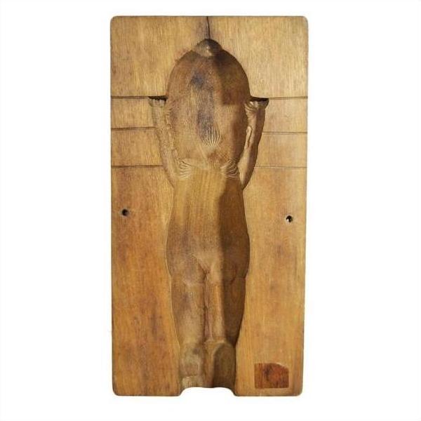 Brown wooden antique Chinese rice mold with intricate carved details, nude female figure, rear view, close-up.