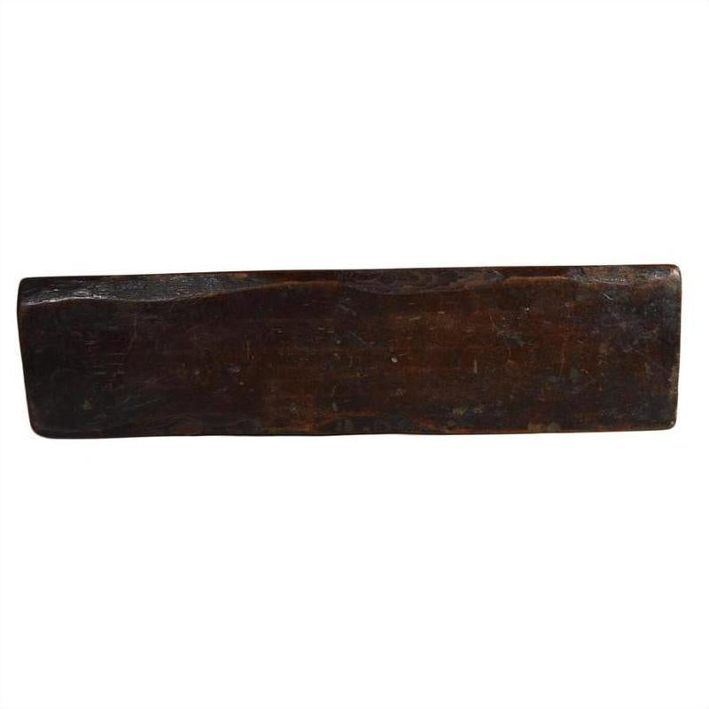 Dark brown rectangular antique Chinese rice mold, wood texture, shown on plain white background, close-up.