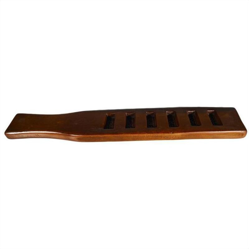 Brown wooden antique Chinese rice mold with five rectangular slots, close-up on plain background.