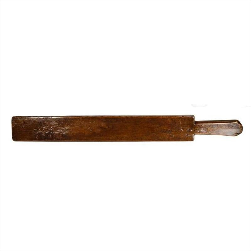 Antique wooden Chinese rice mold with small handle against a plain white background.