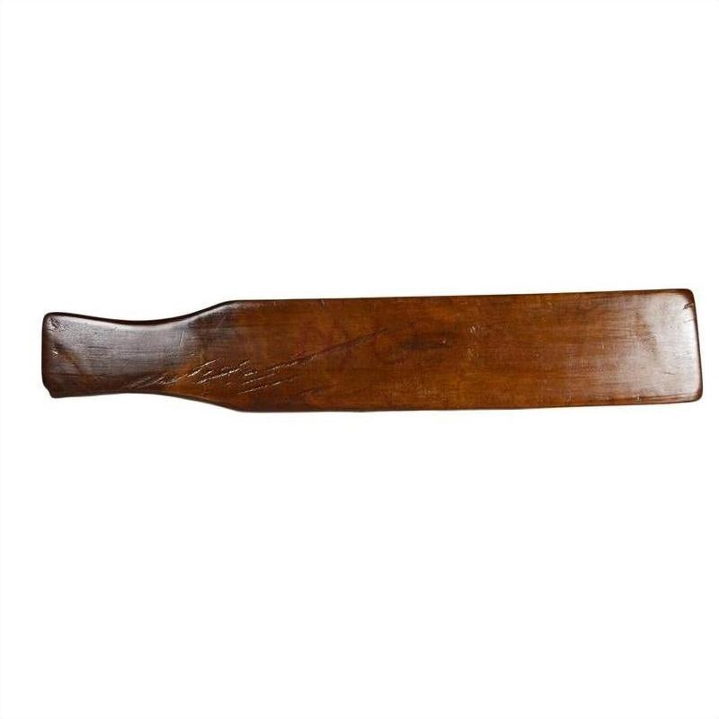 Brown antique wood Chinese rice mold with five rectangular character cavities, close-up on table.