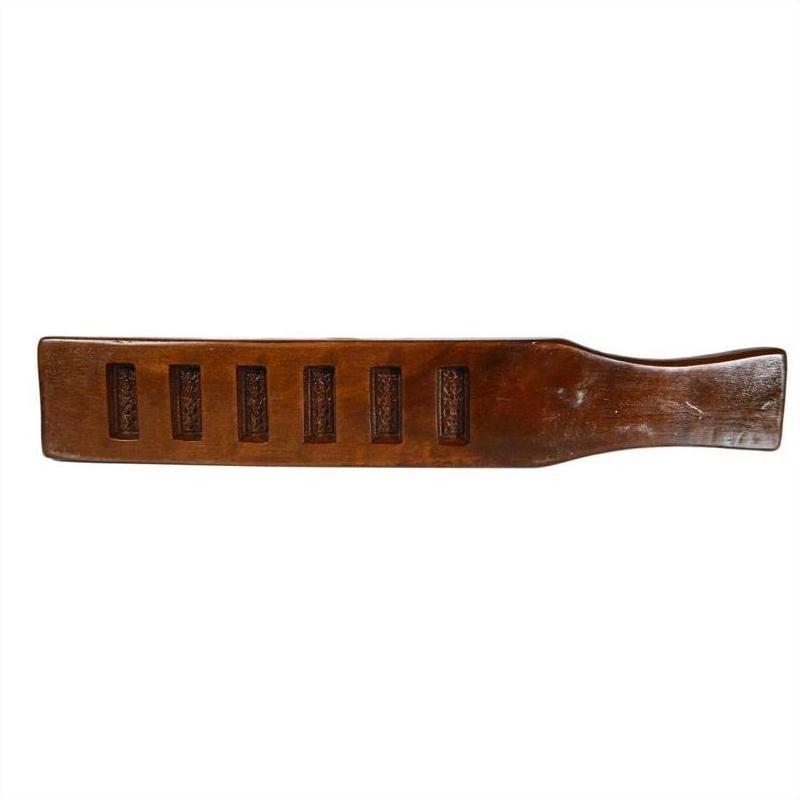 Wood antique Chinese rice mold with handle and five rectangular character cavities, close-up on plain background.