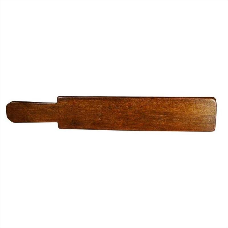 Brown antique Chinese wooden rice mold with five leaf bud impressions and symmetrical floral motif, close-up view.