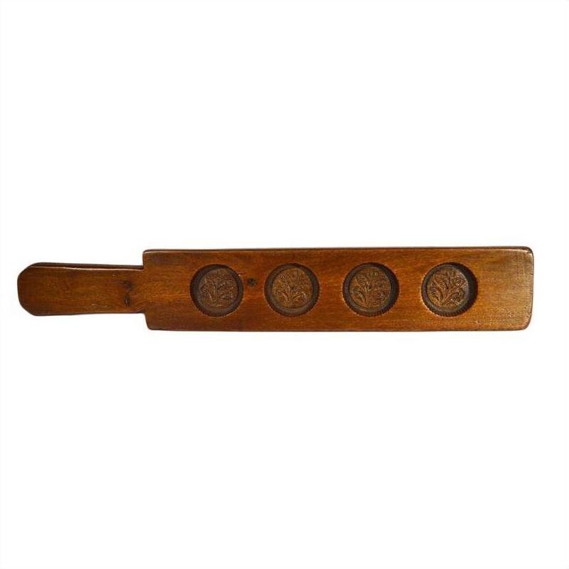 Brown antique Chinese wood rice mold with five floral leaf bud motifs and sturdy left handle, close-up view.