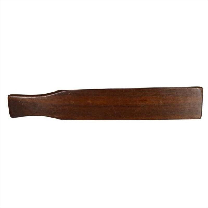 Brown wooden antique Chinese rice mold with six character cavities and curved paddle handle on a white background.