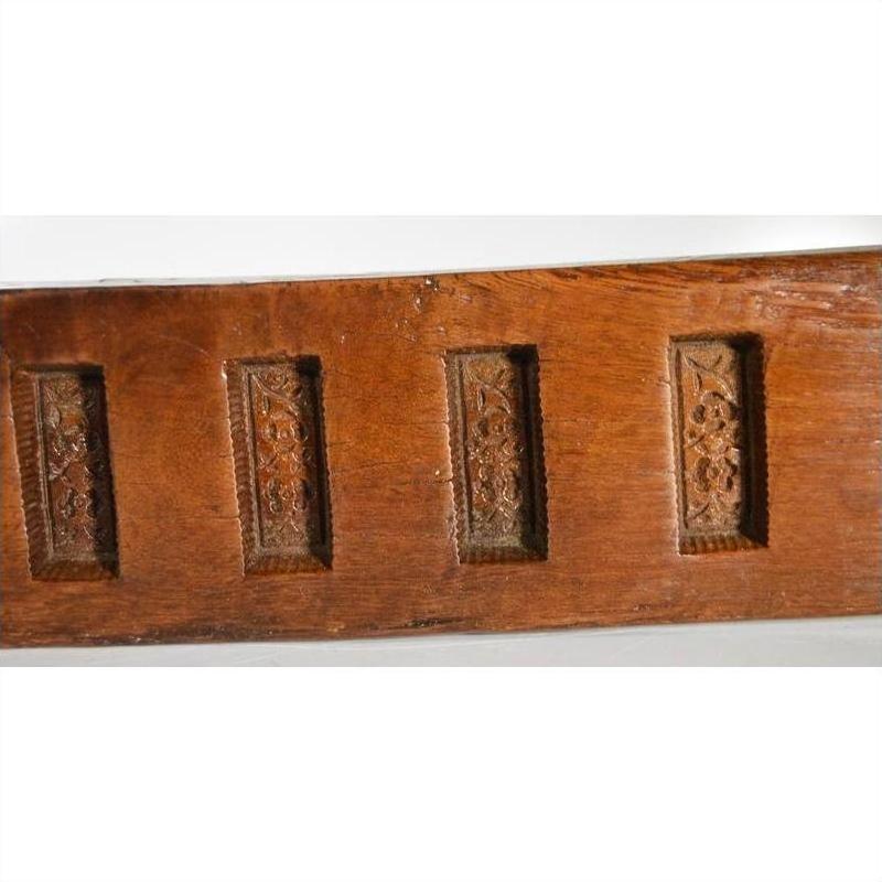 Close-up of dark wood antique Chinese rice mold with six rectangular seal carvings.