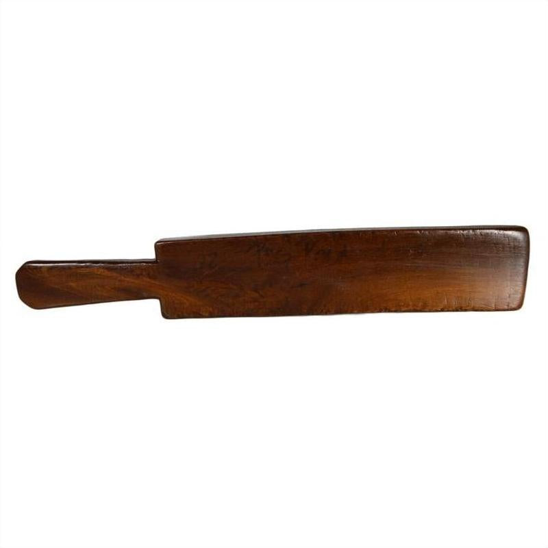 Dark wood antique Chinese rice mold with six rectangular seal carvings, close-up view.