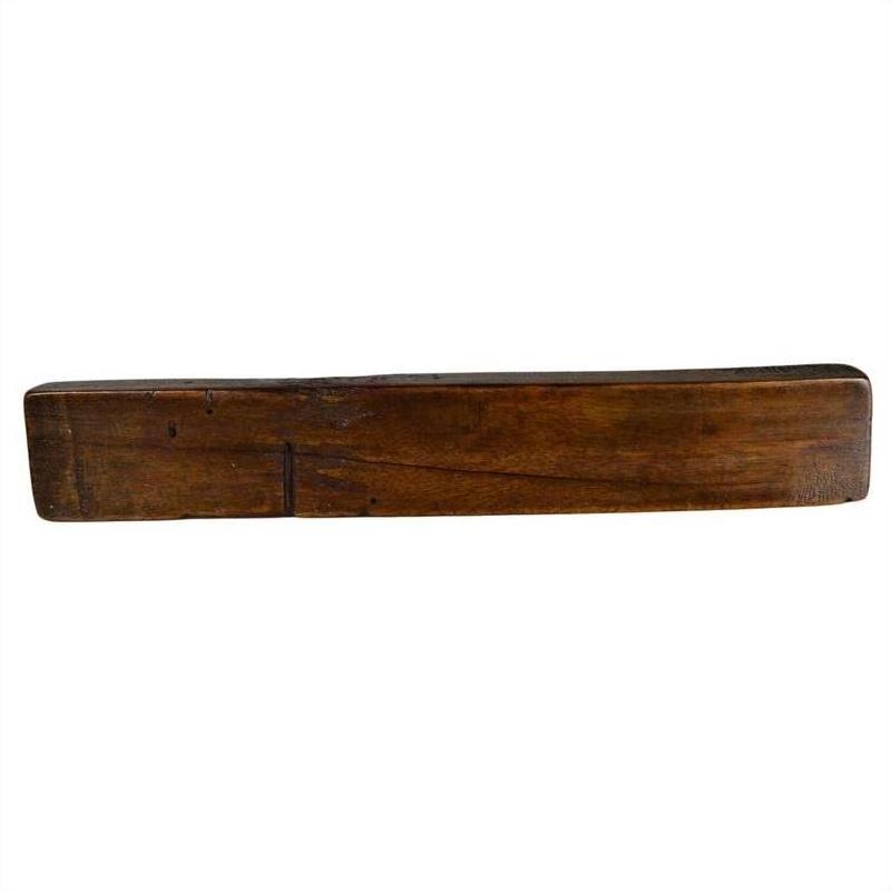 Brown wooden antique Chinese rice mold with mixed symbol carvings and five cavities on a plain white background.
