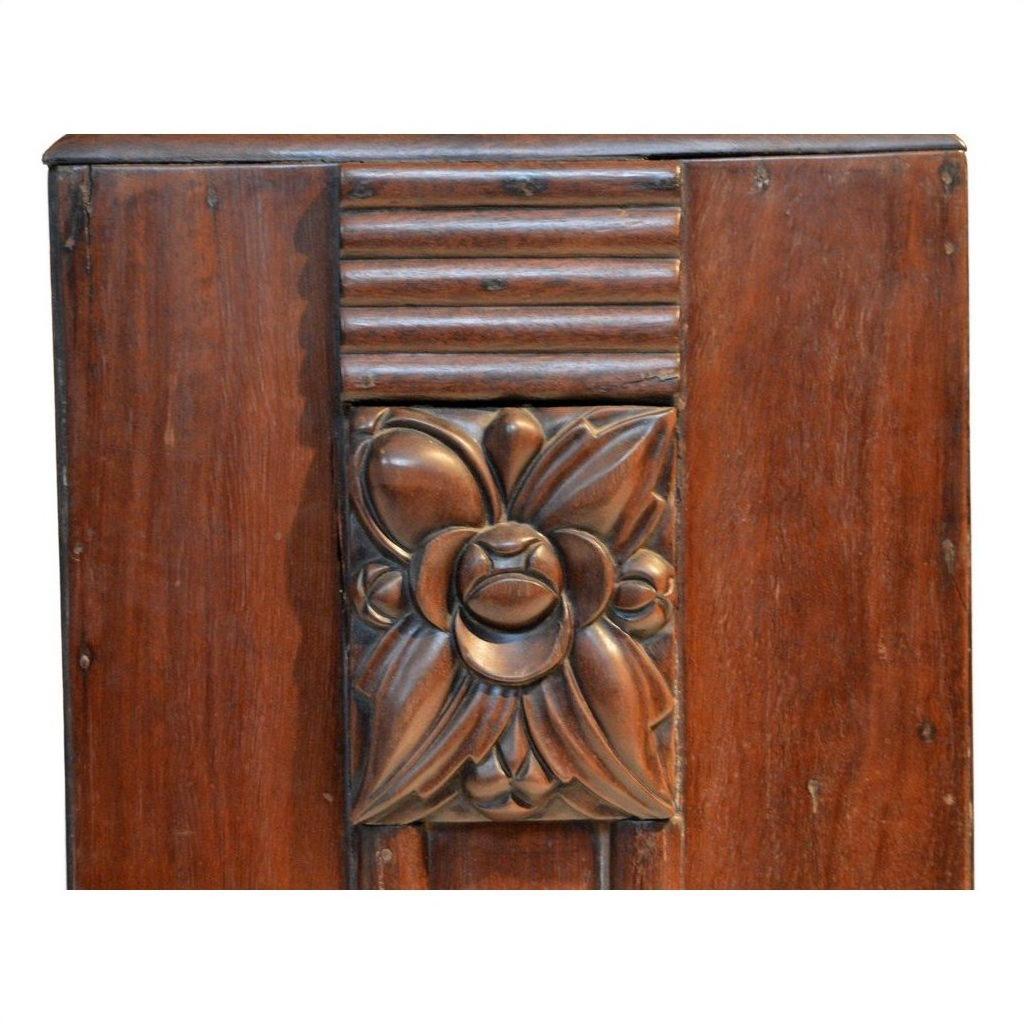 Dark rosewood side table with carved floral center and horizontal grooves, shown in a neutral setting.